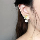 Camellia Cream Drop Earrings in Mustard Yellow Model