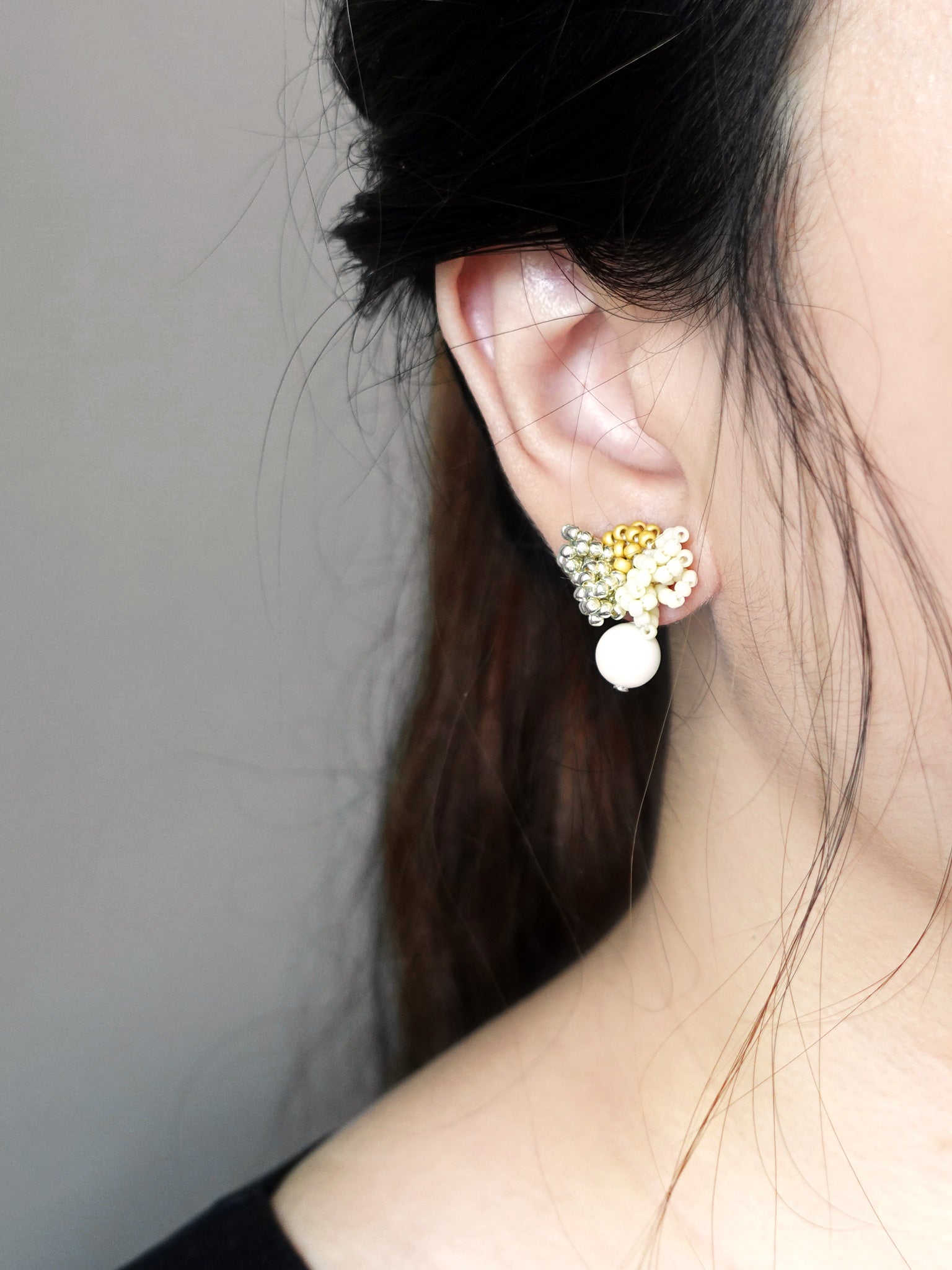 Camellia Cream Drop Earrings in Mustard Yellow Model