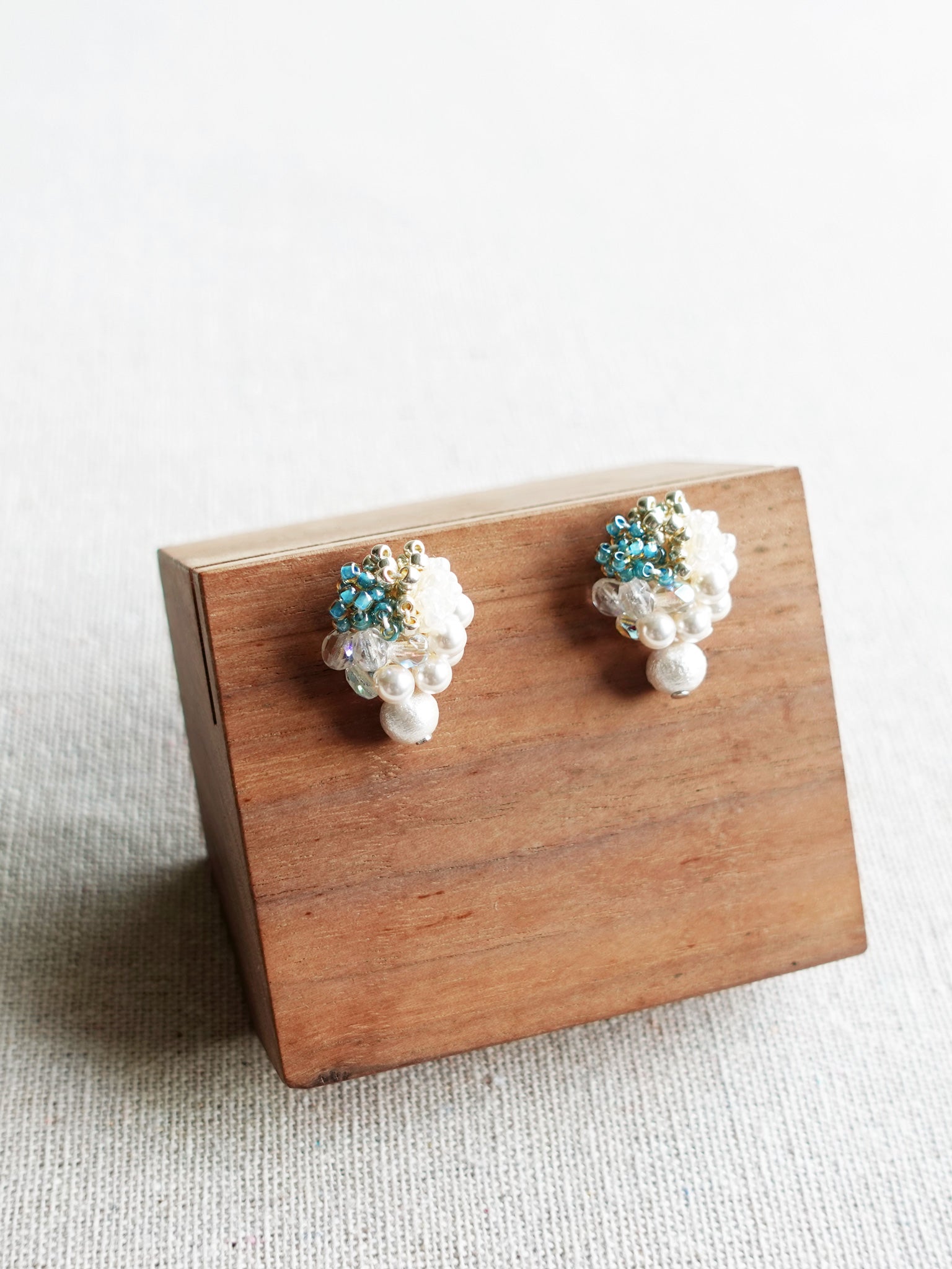 Fantasia Snowball Earrings in Ocean Green Display Left