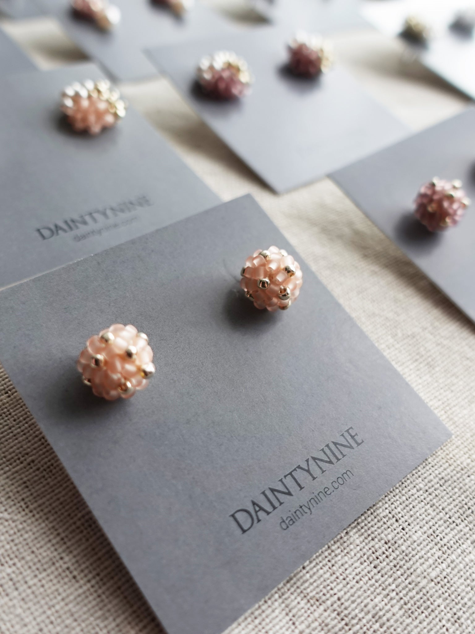 Orb Star Dust Stud Earrings in Blush Pink Card Close Up