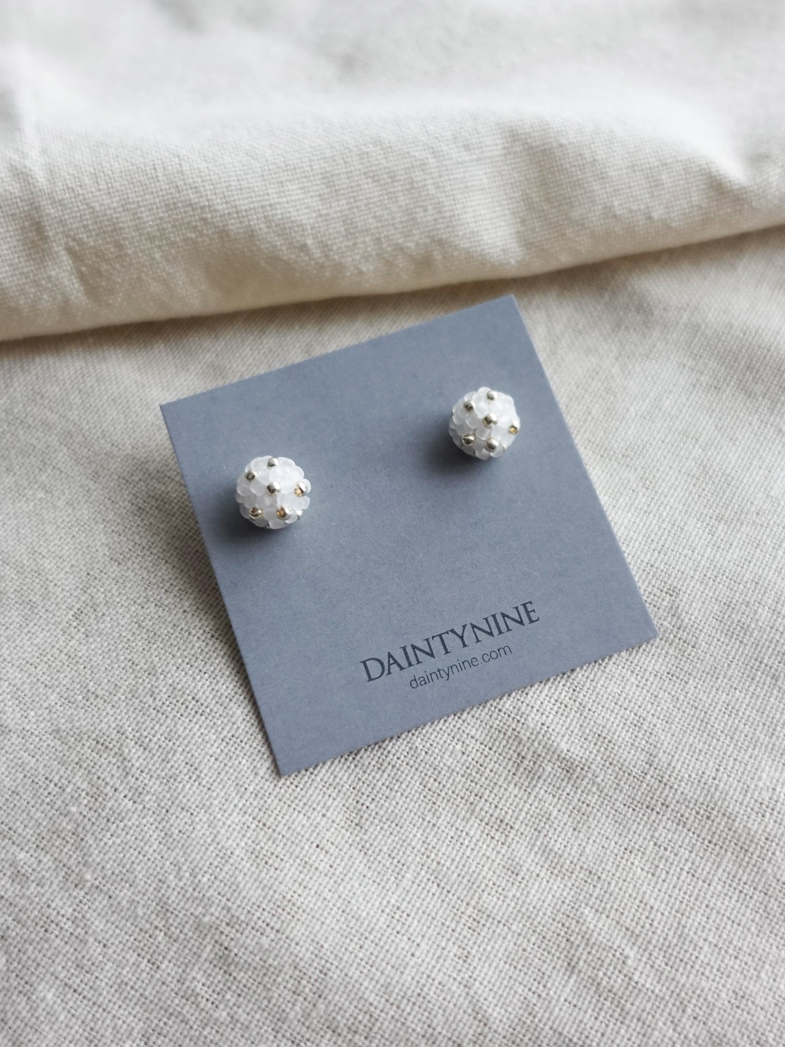 Orb Star Dust Stud Earrings in Cloud White Card