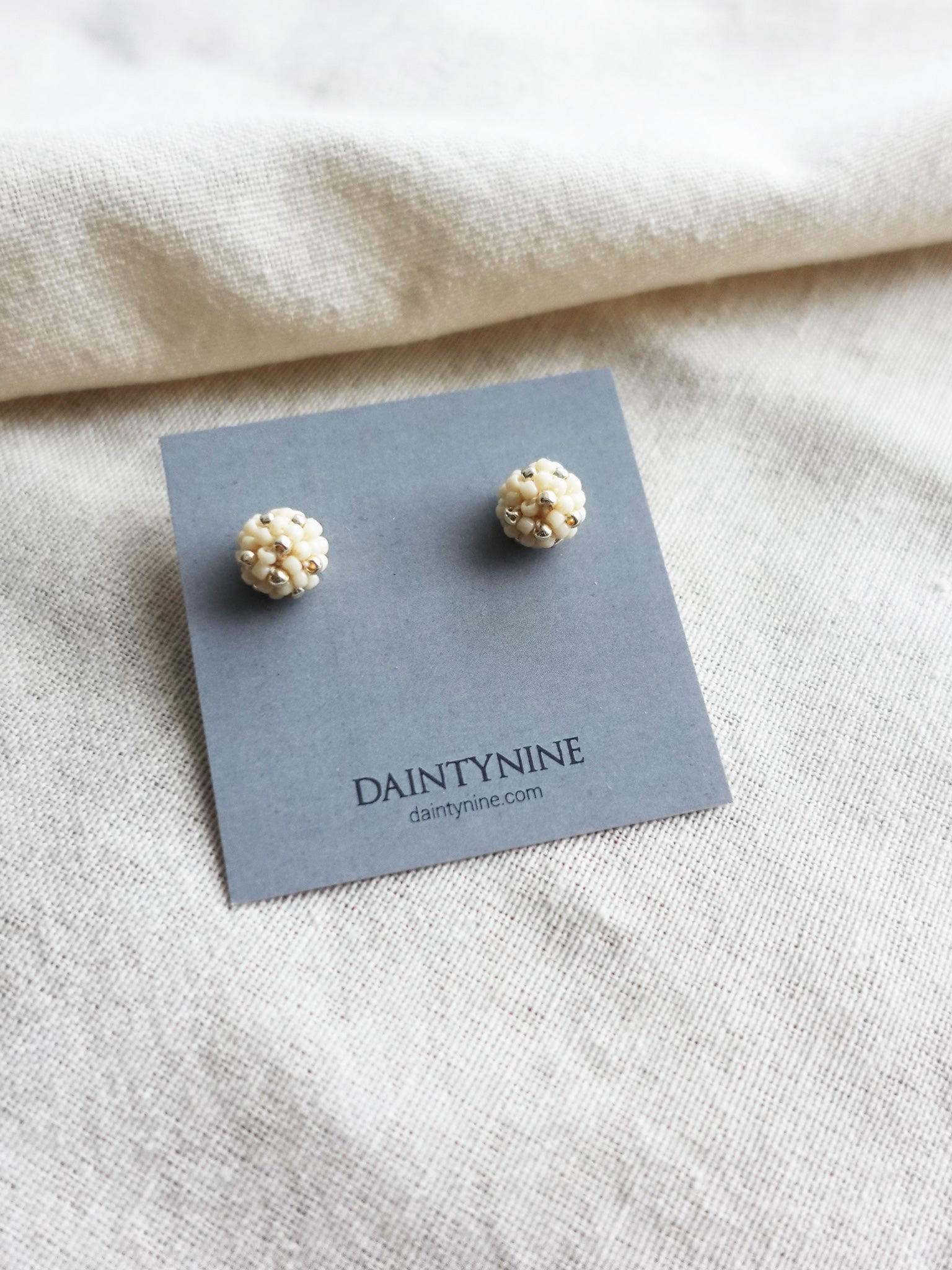 Orb Star Dust Stud Earrings in Milk White Card