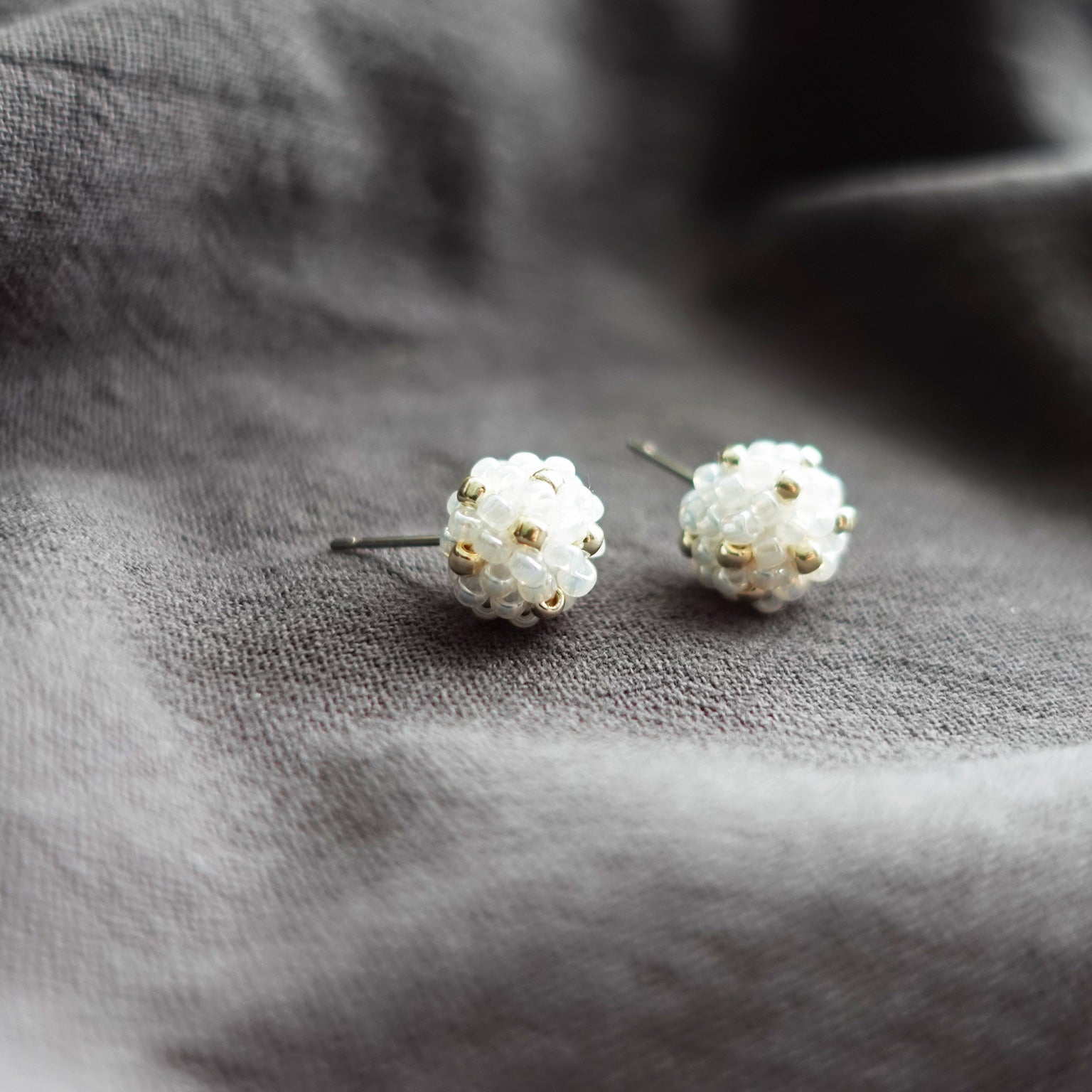 Orb Star Dust Stud Earrings in White Front