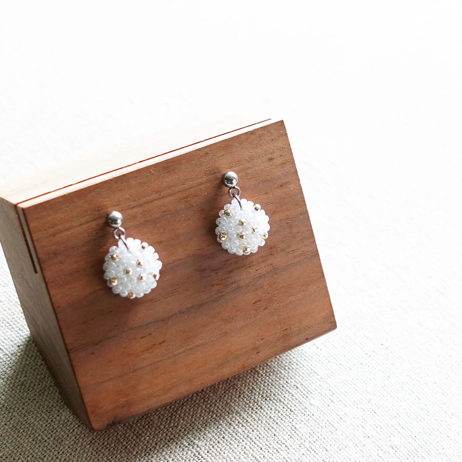 Star Dust Delica Drop Earrings in White Display Front