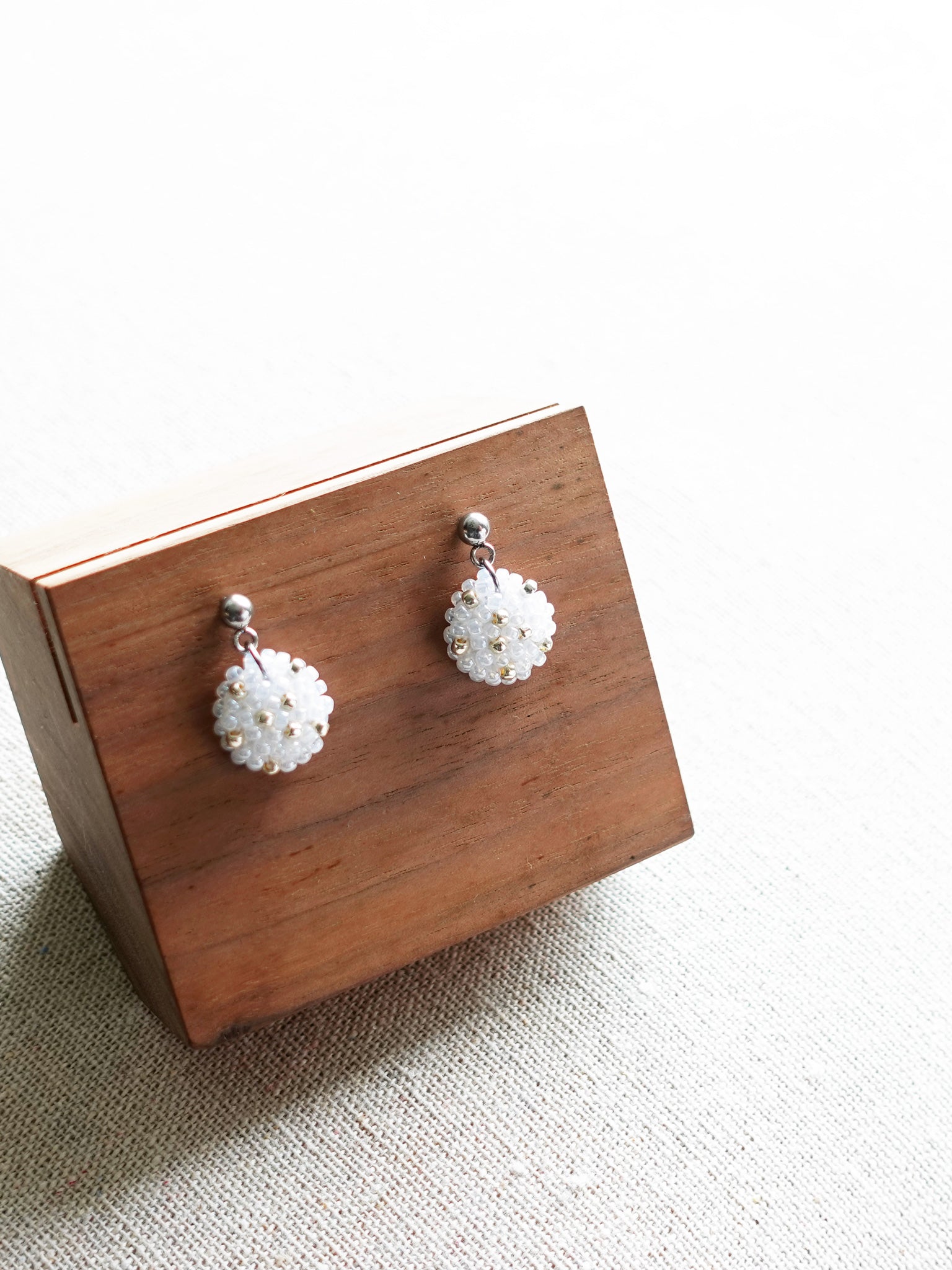 Star Dust Delica Drop Earrings in White Display Front