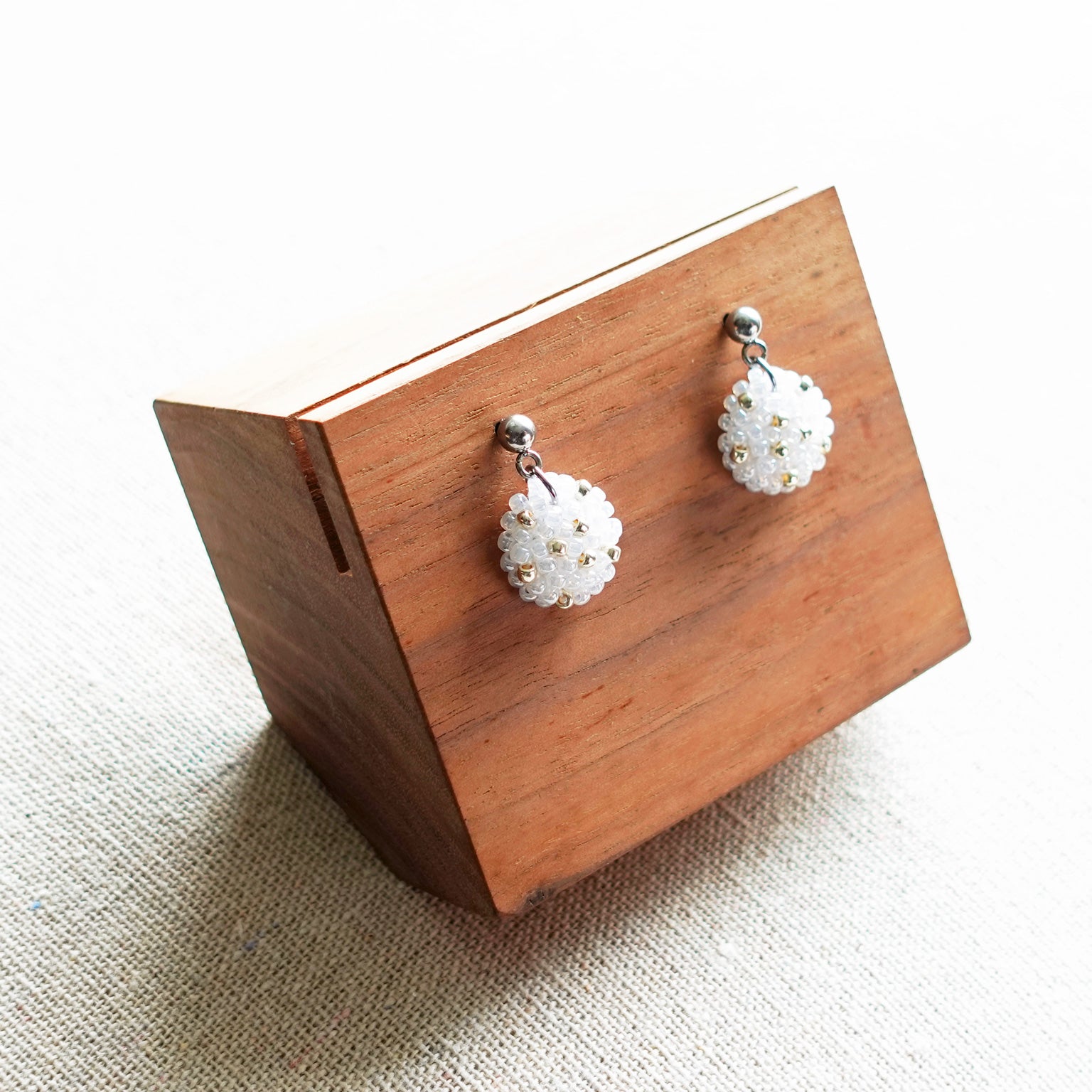 Star Dust Delica Drop Earrings in White Display Left