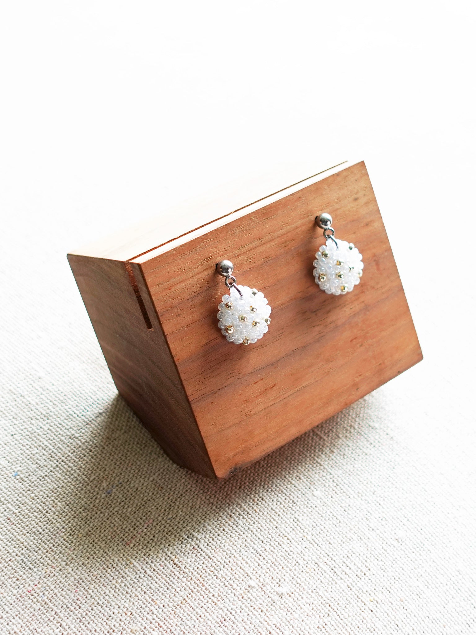 Star Dust Delica Drop Earrings in White Display Left