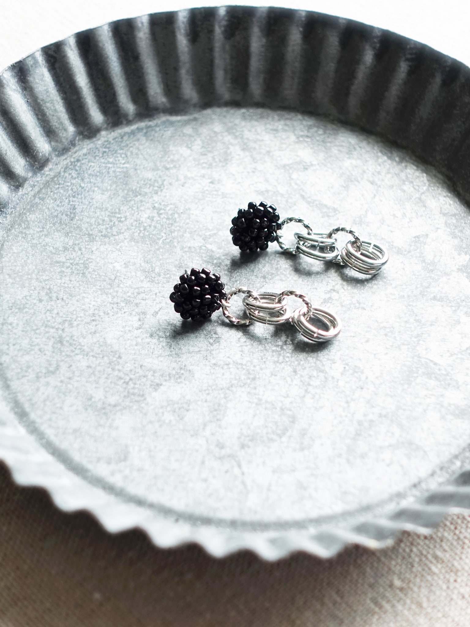 Xanthia Earrings in Black Tray Left
