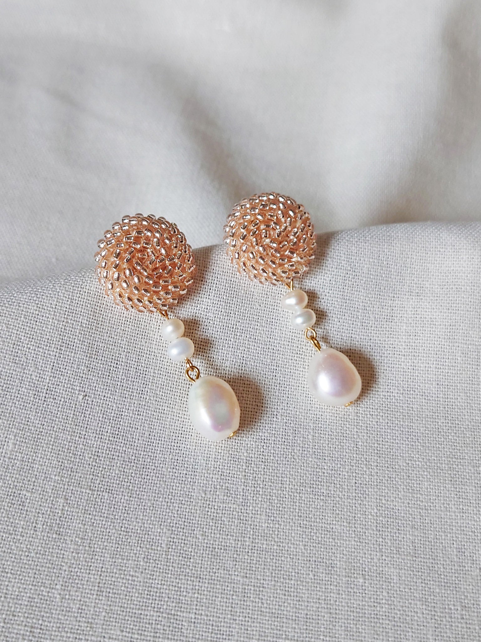 Calypso Dangle Earrings in Champagne Pink Left 1