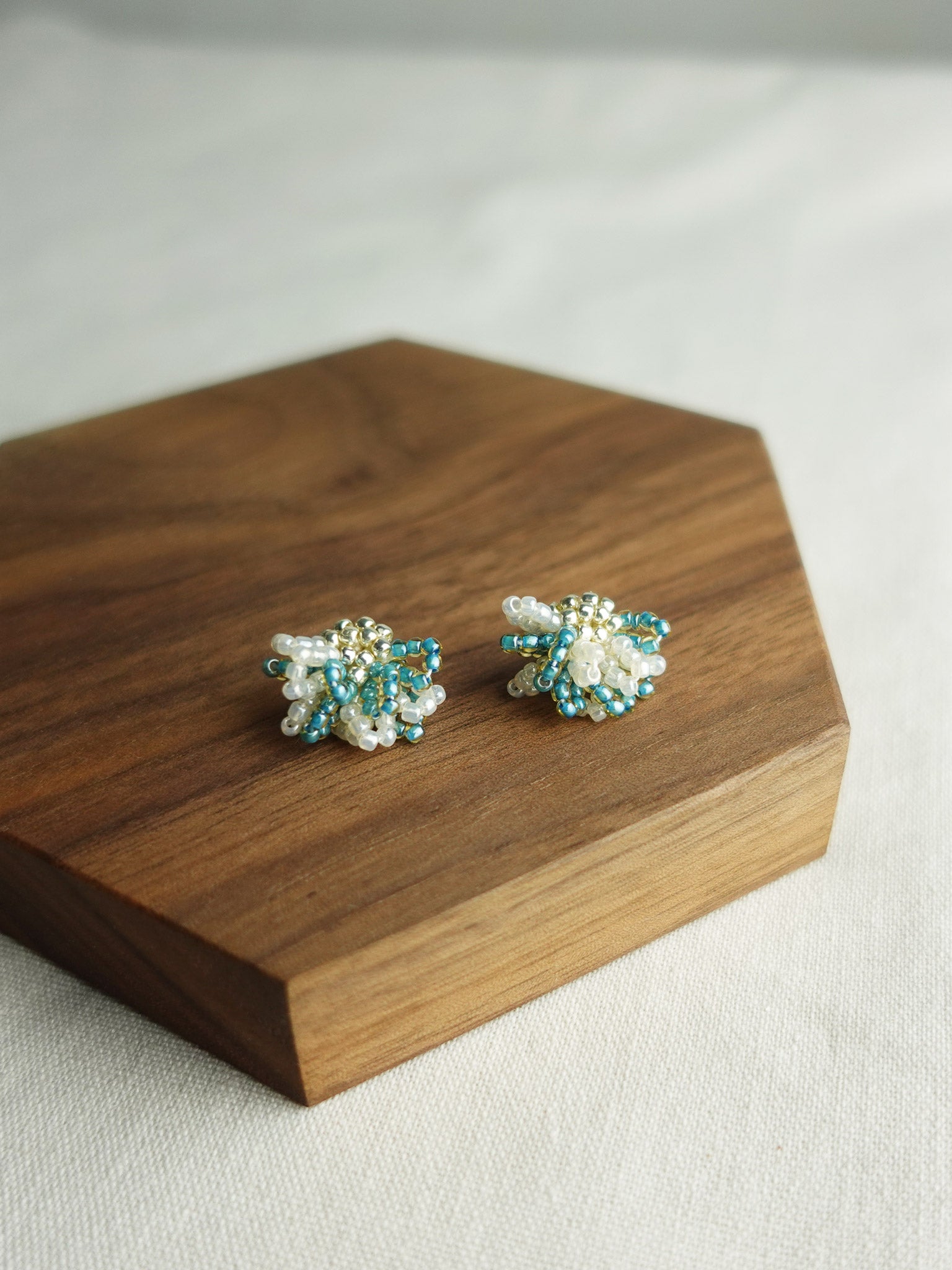 Camellia Bicolor Stud Earrings in Ocean Green Display Front