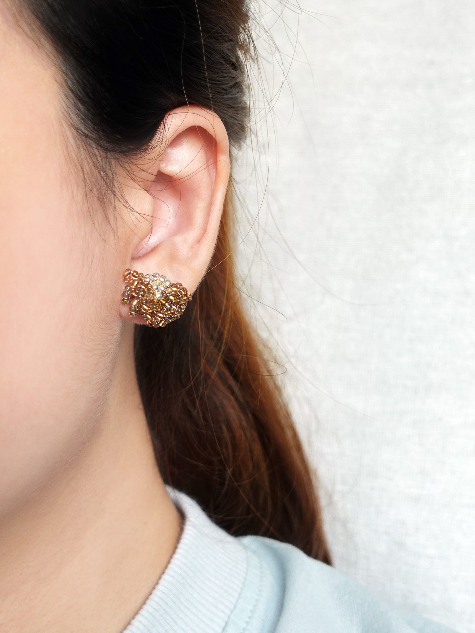 Camellia Stud Earrings in Caramel Brown Model