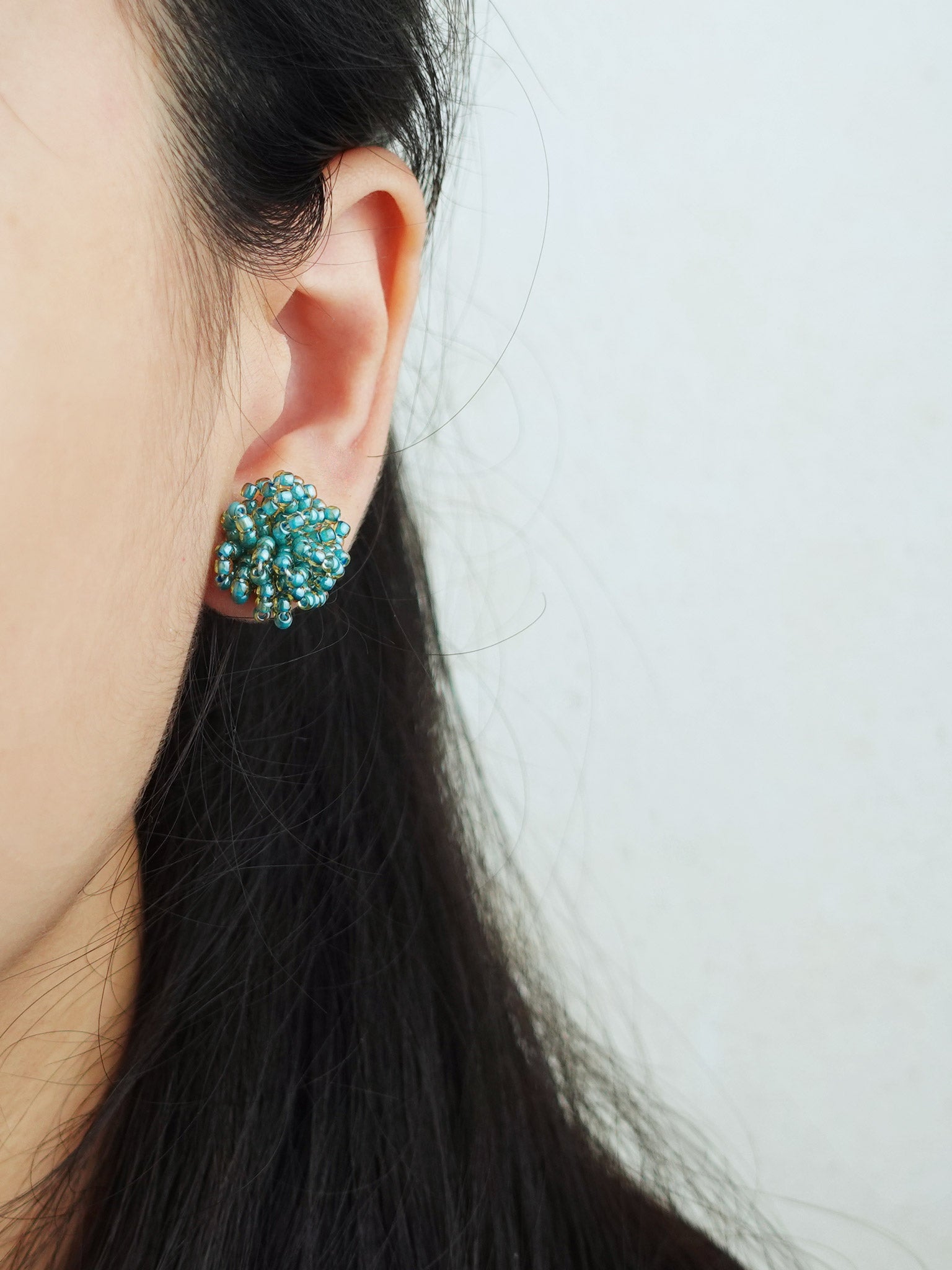 Fluffy Earrings in Ocean Green Model