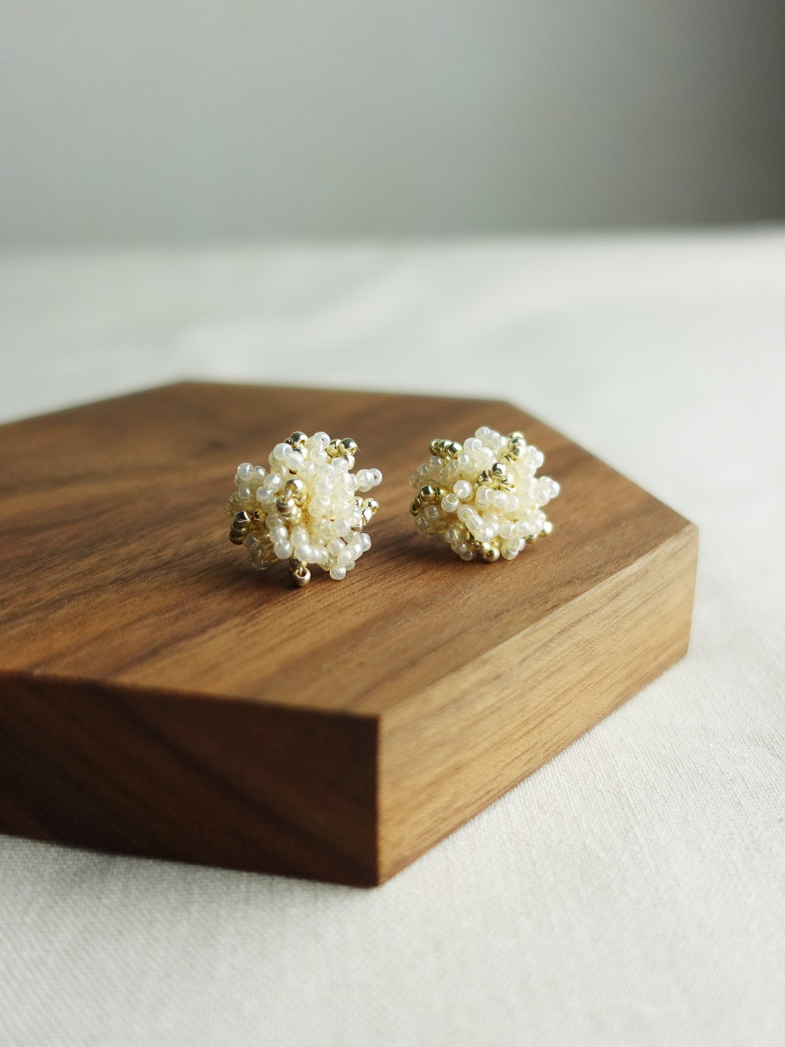Fluffy Star Dust Earrings in Ivory Display Left