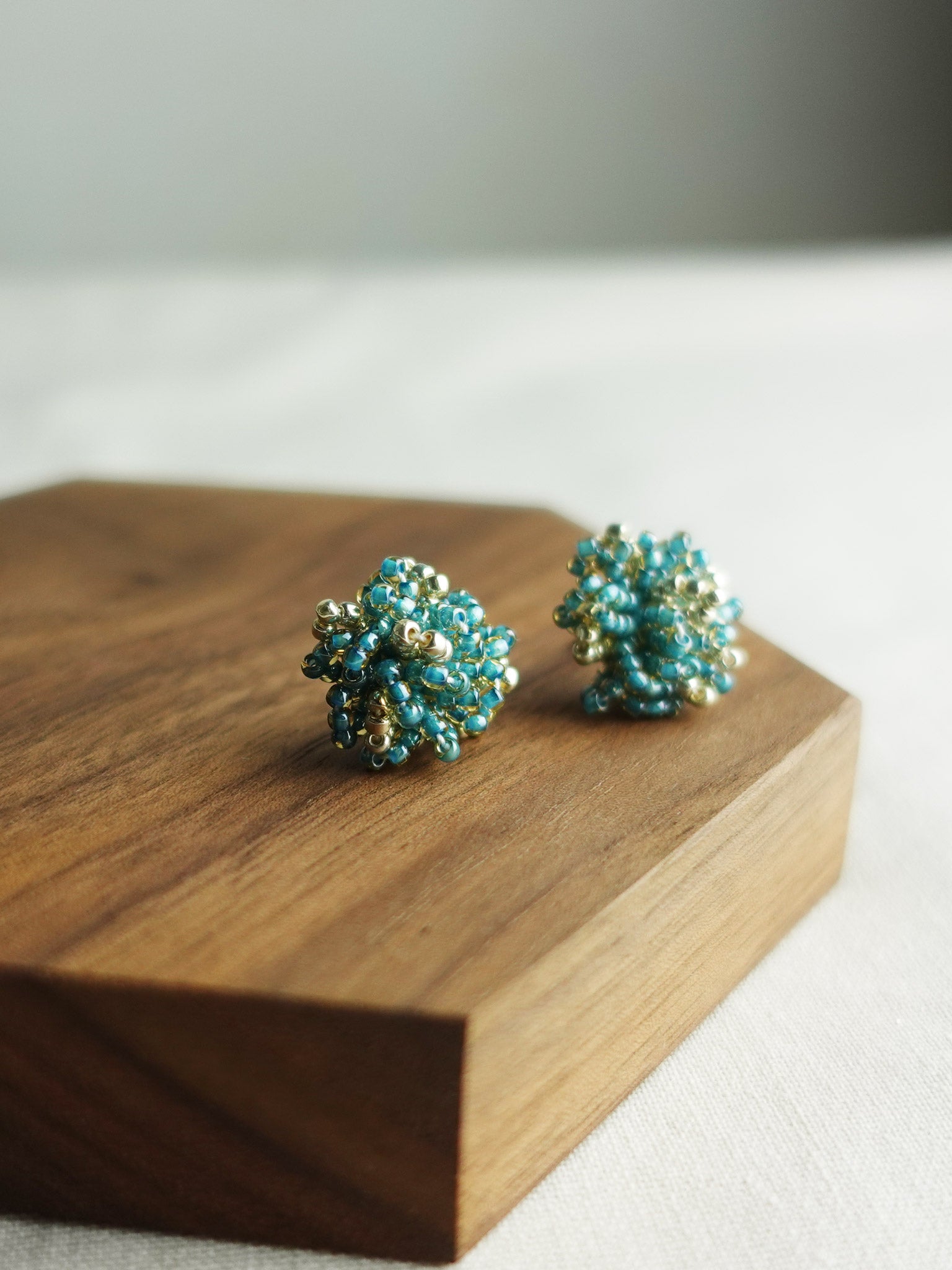 Fluffy Star Dust Earrings in Ocean Green Display Left