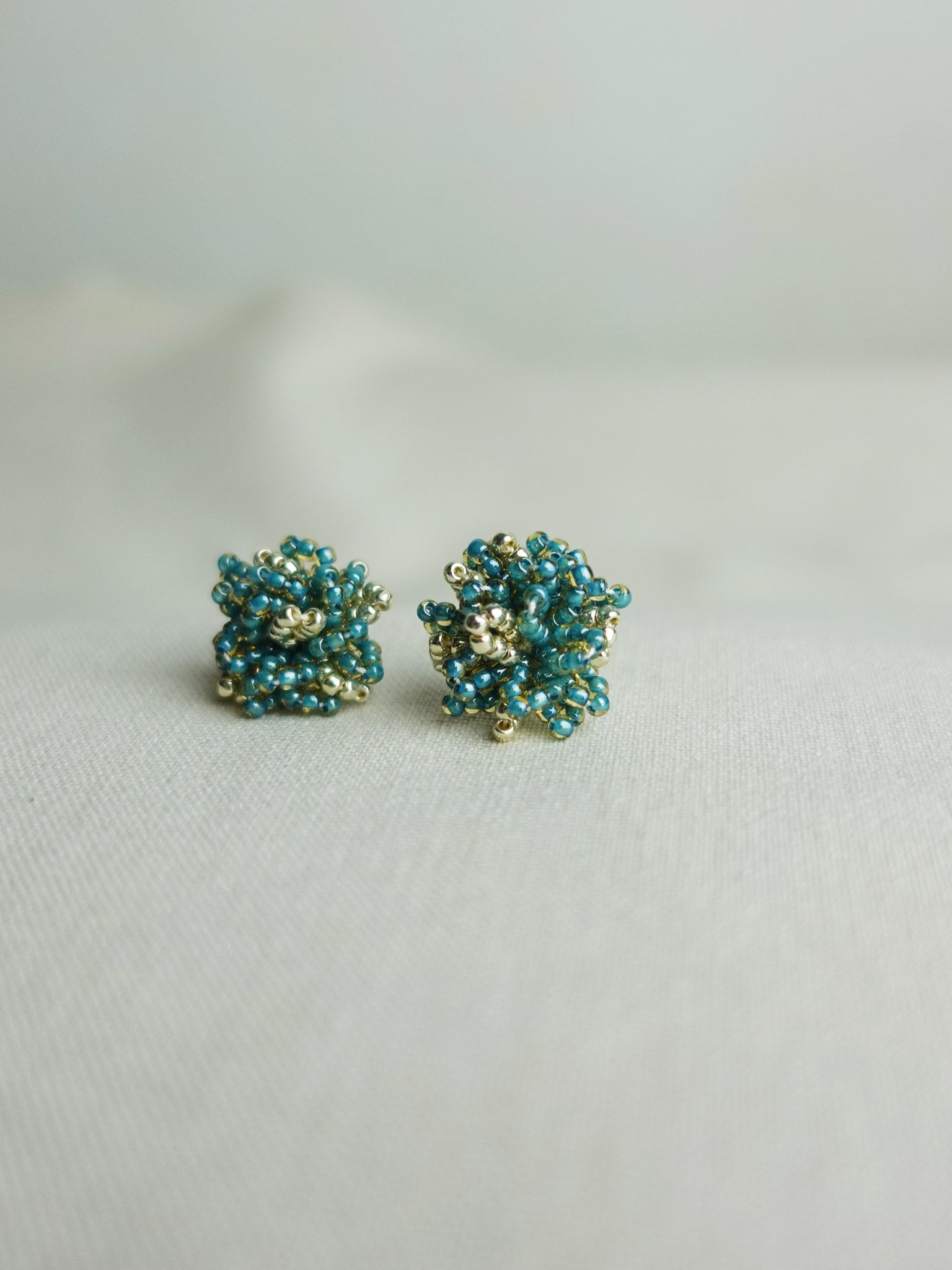 Fluffy Star Dust Earrings in Ocean Green Front