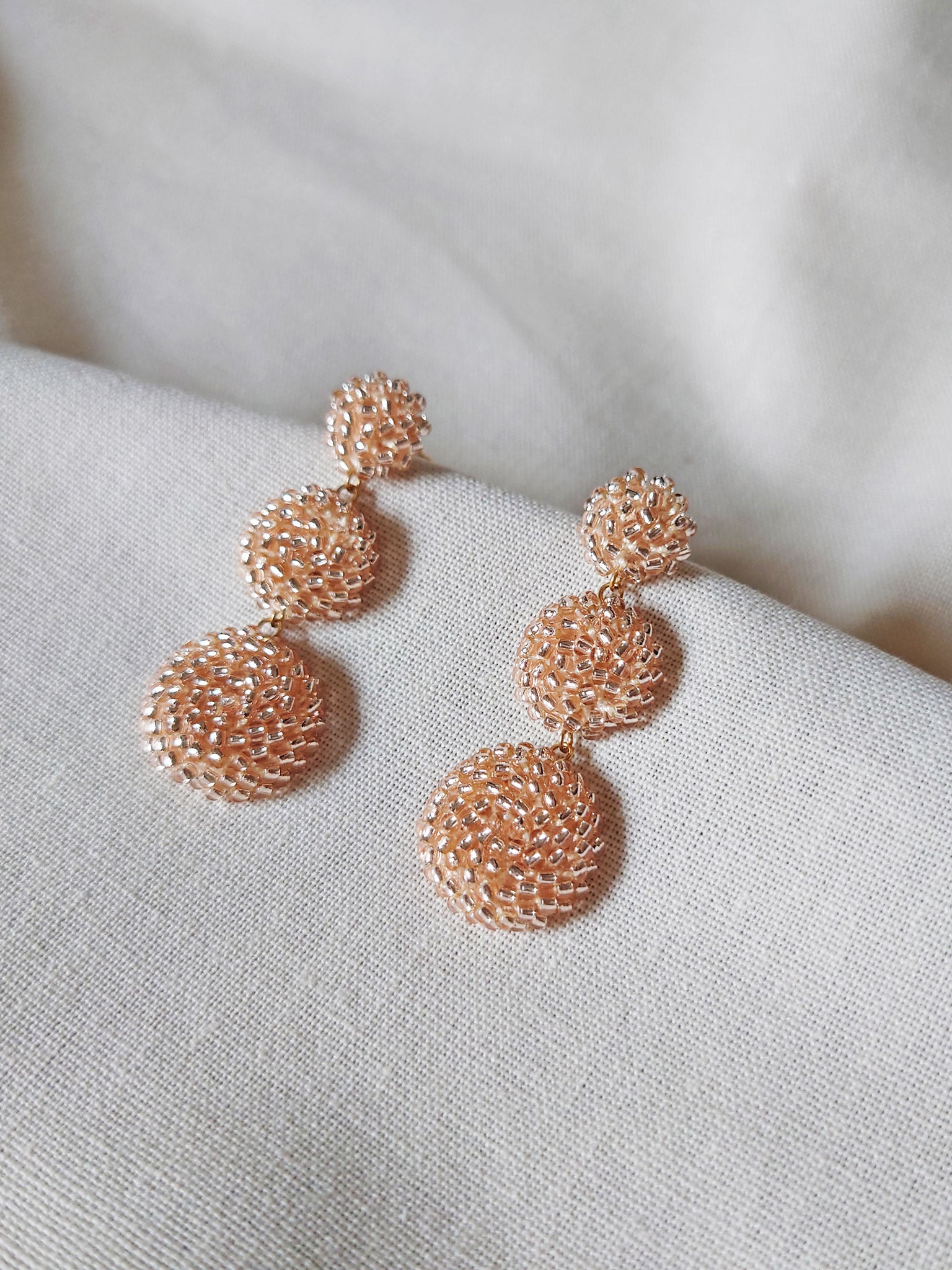 Juno Dangle Earrings in Champagne Pink Front