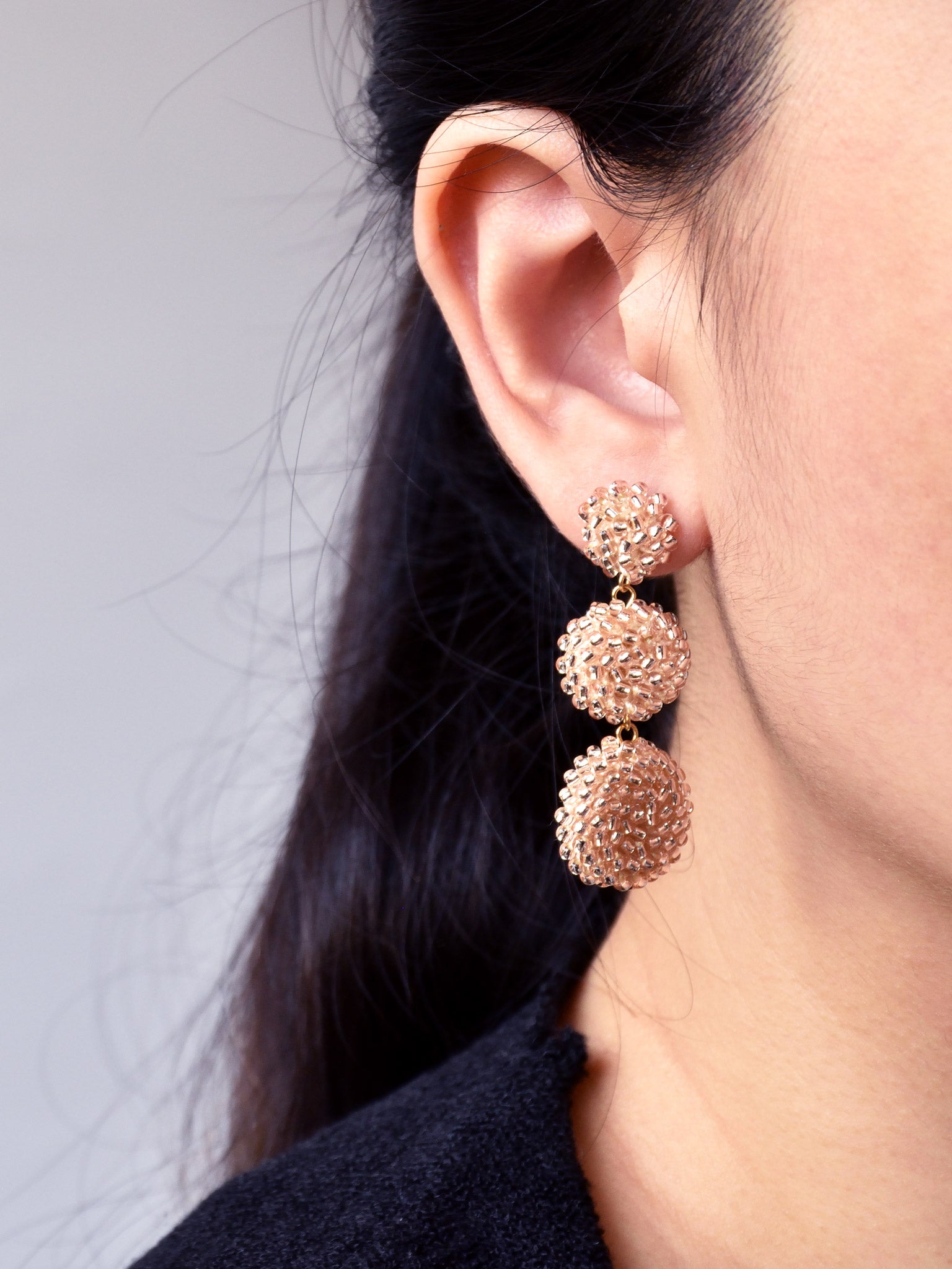 Juno Dangle Earrings in Champagne Pink Model