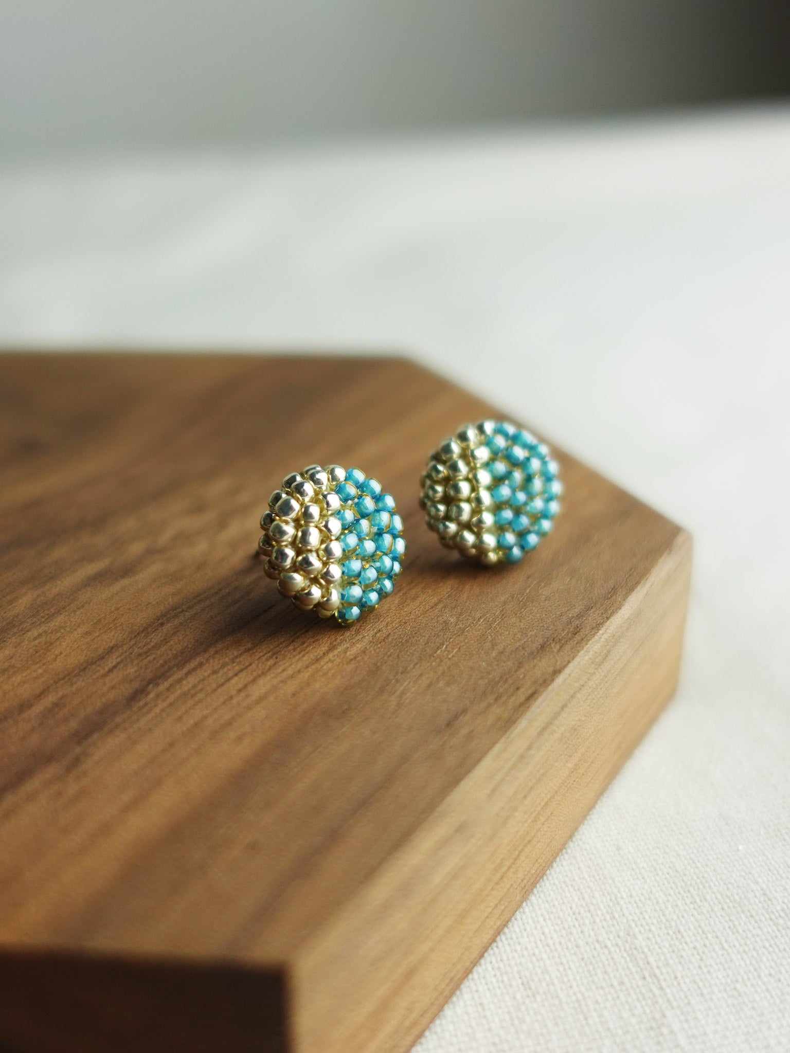 Last Quarter Delica Stud Earrings in Ocean Green Display