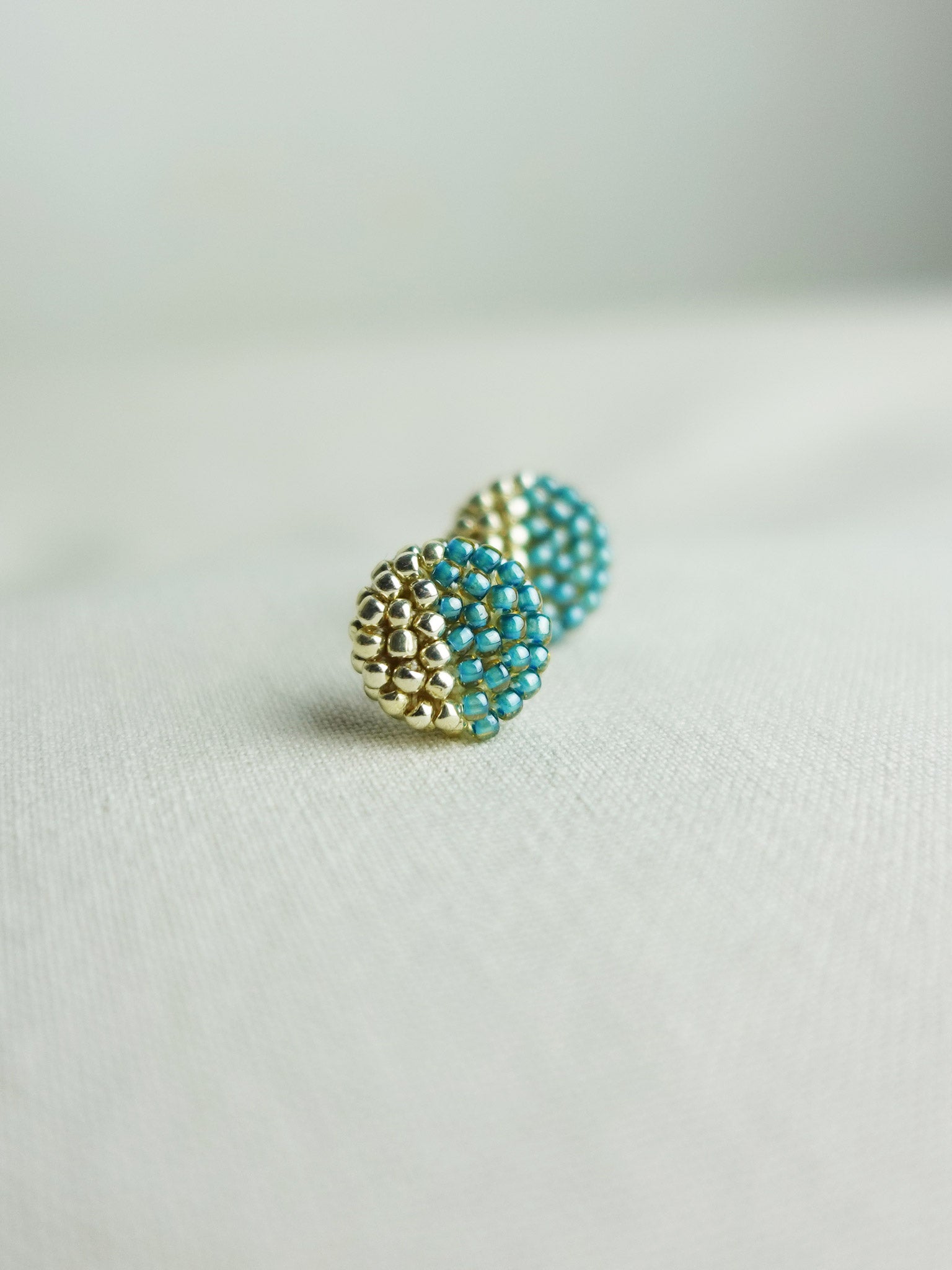 Last Quarter Delica Stud Earrings in Ocean Green Left