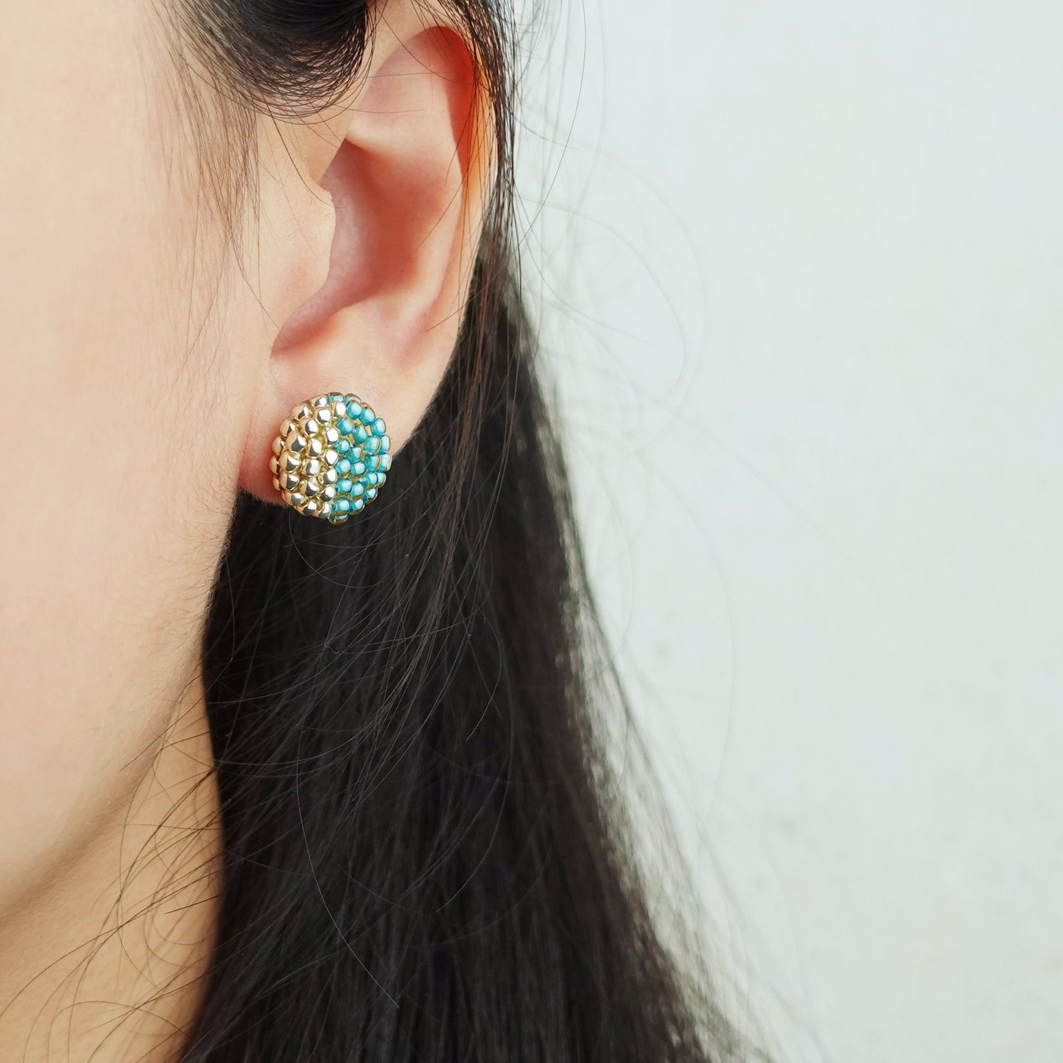 Last Quarter Delica Stud Earrings in Ocean Green Model