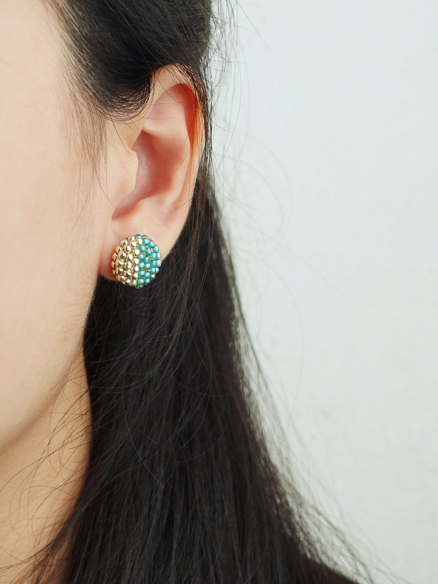 Last Quarter Delica Stud Earrings in Ocean Green Model