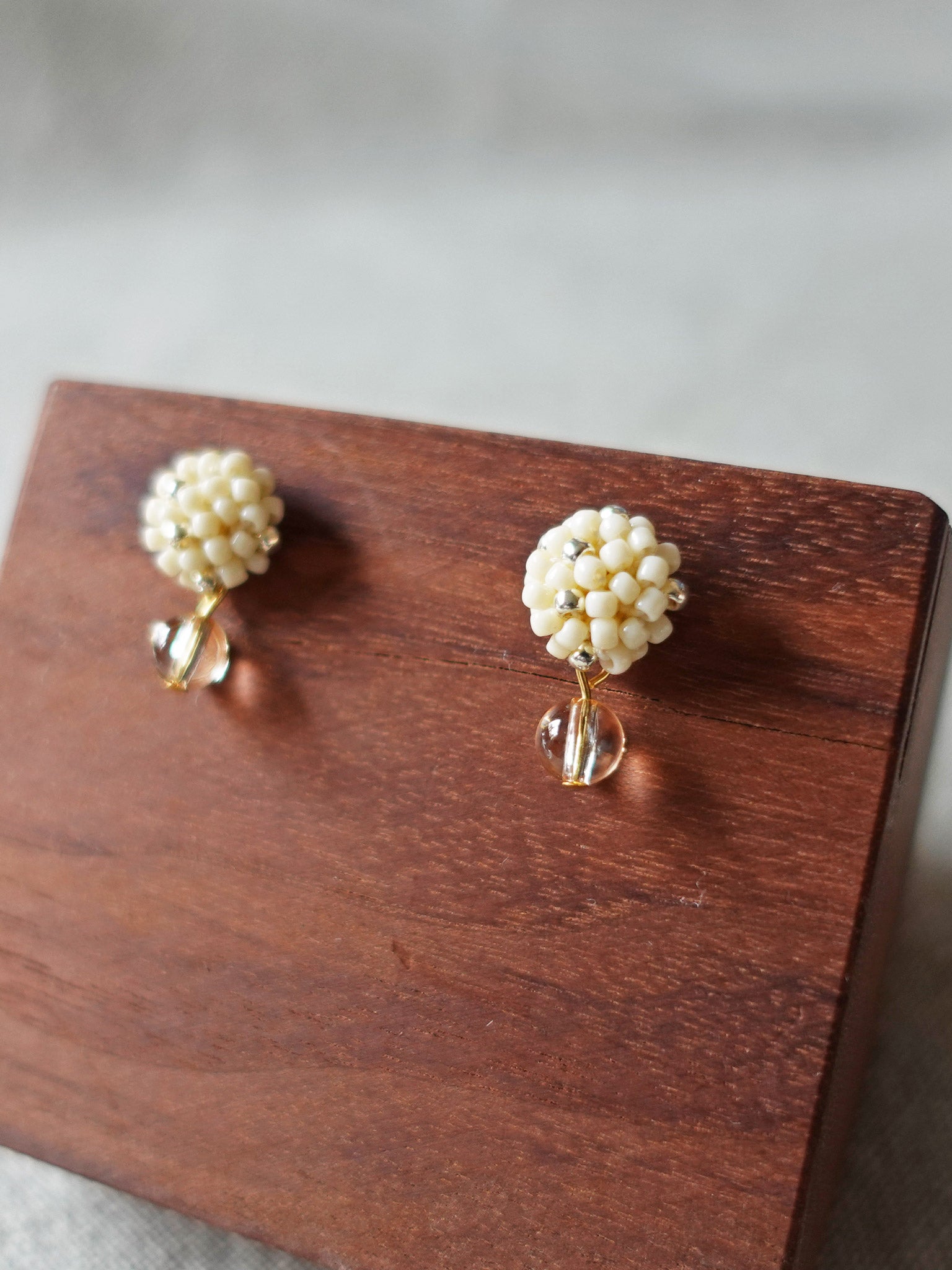 Layna Globe Earrings in Milk White Display