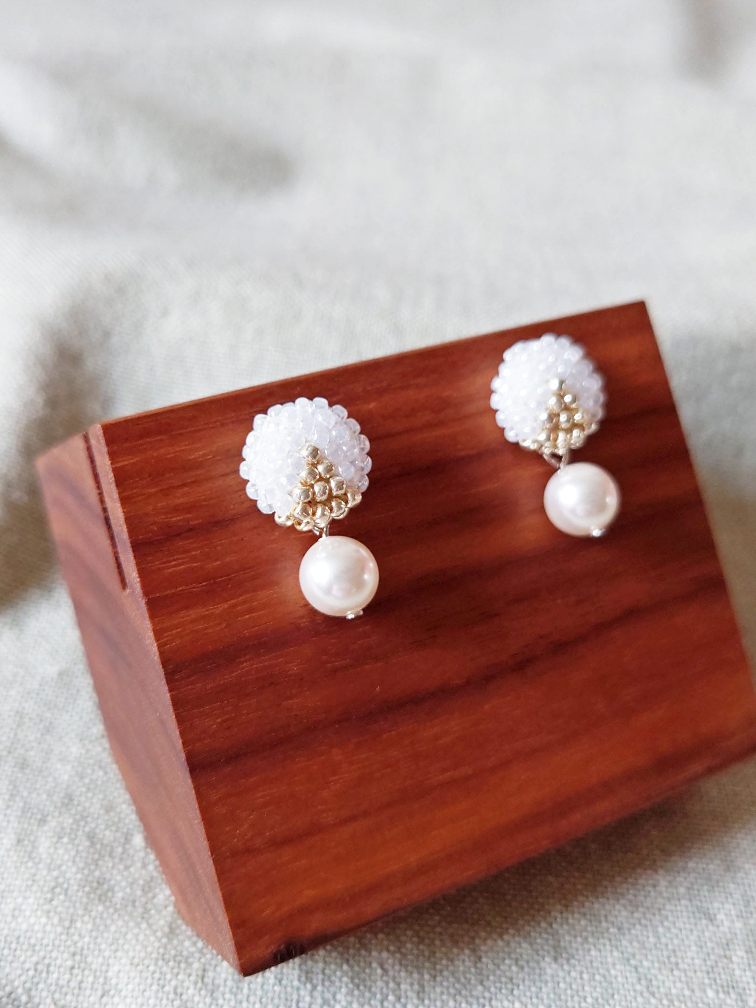 Mariota Two Ninths Earrings in White Display Front