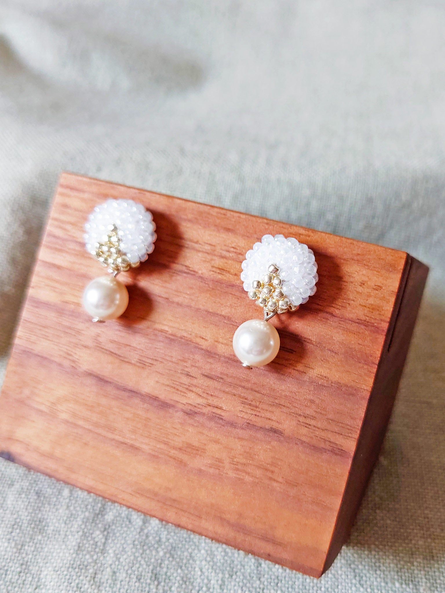 Mariota Two Ninths Earrings in White Display Side
