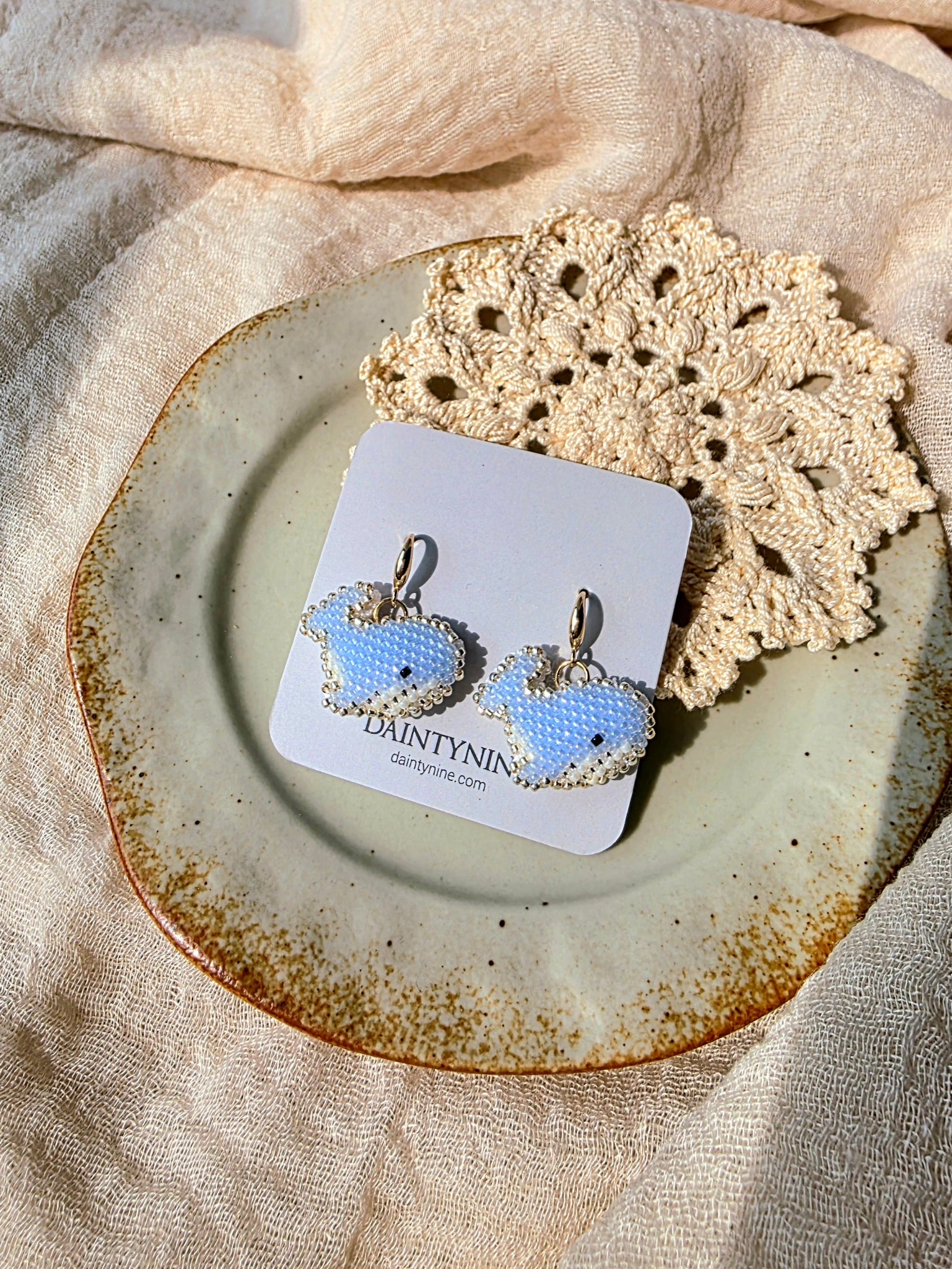 Blue whale drop earrings on card