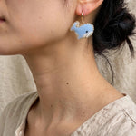 Blue whale drop earrings on model