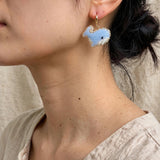 Blue whale drop earrings on model