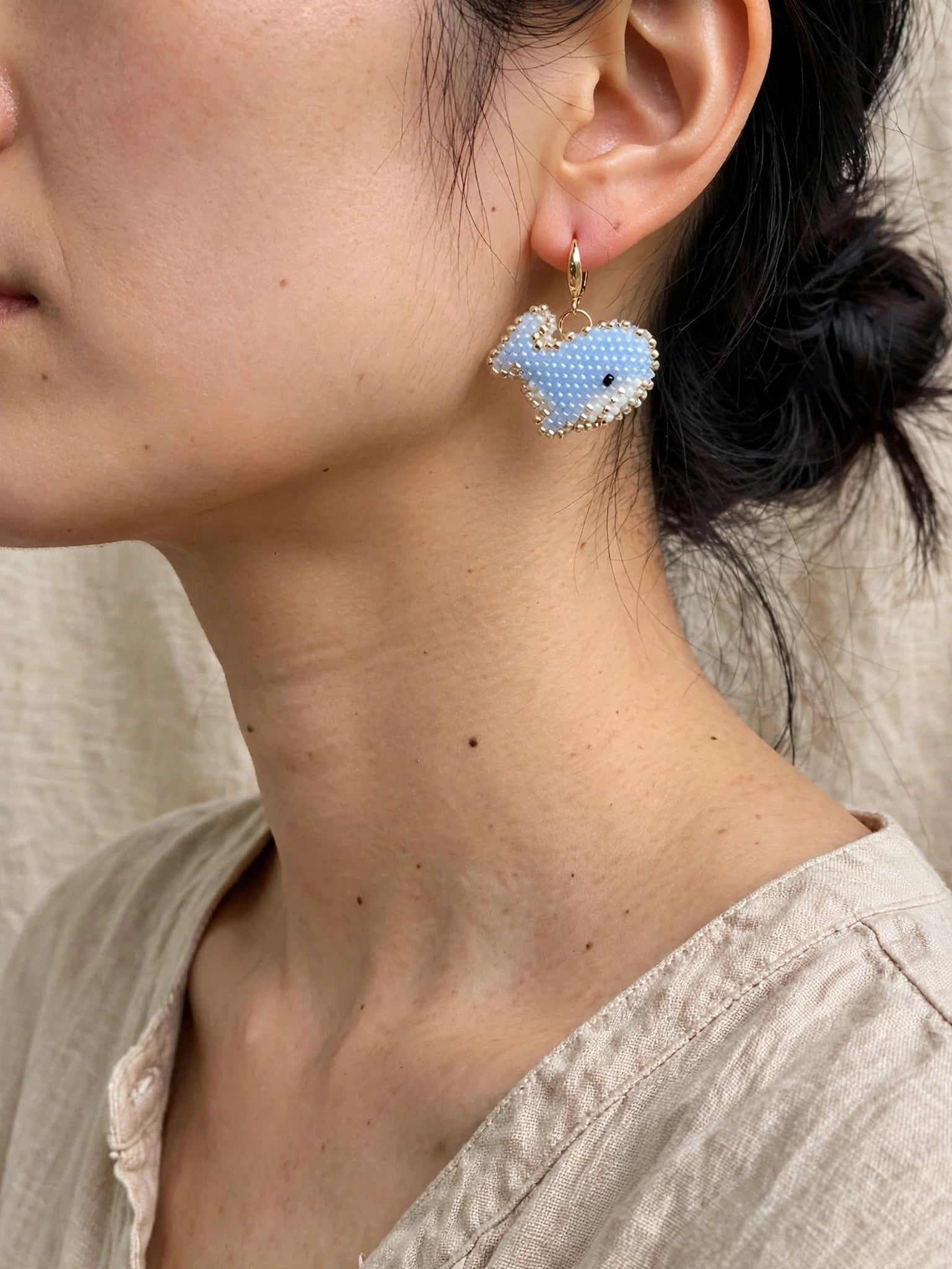Blue whale drop earrings on model