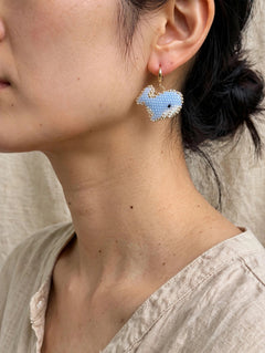 Blue whale drop earrings on model