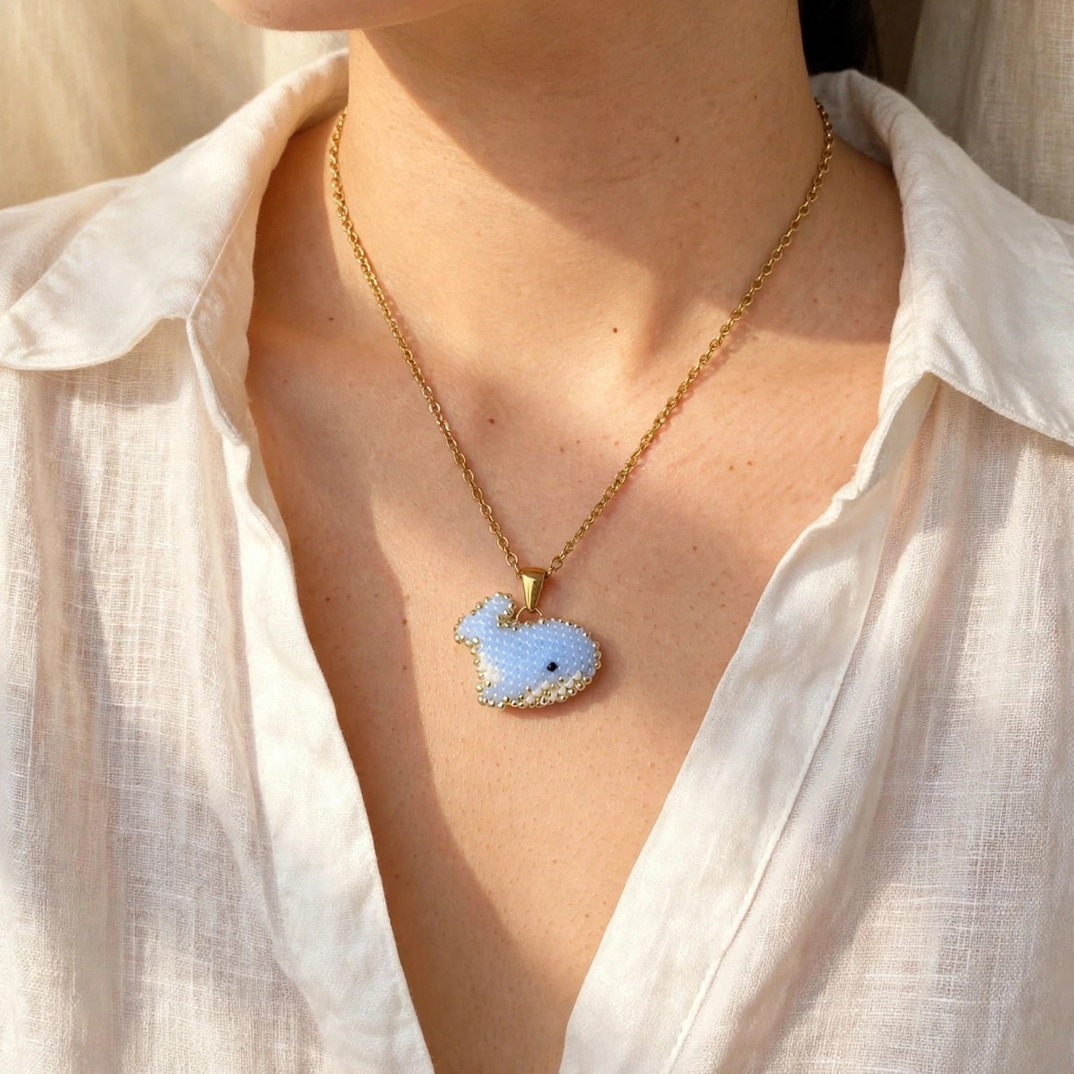 Blue whale necklace on model