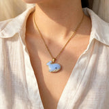 Blue whale necklace on model