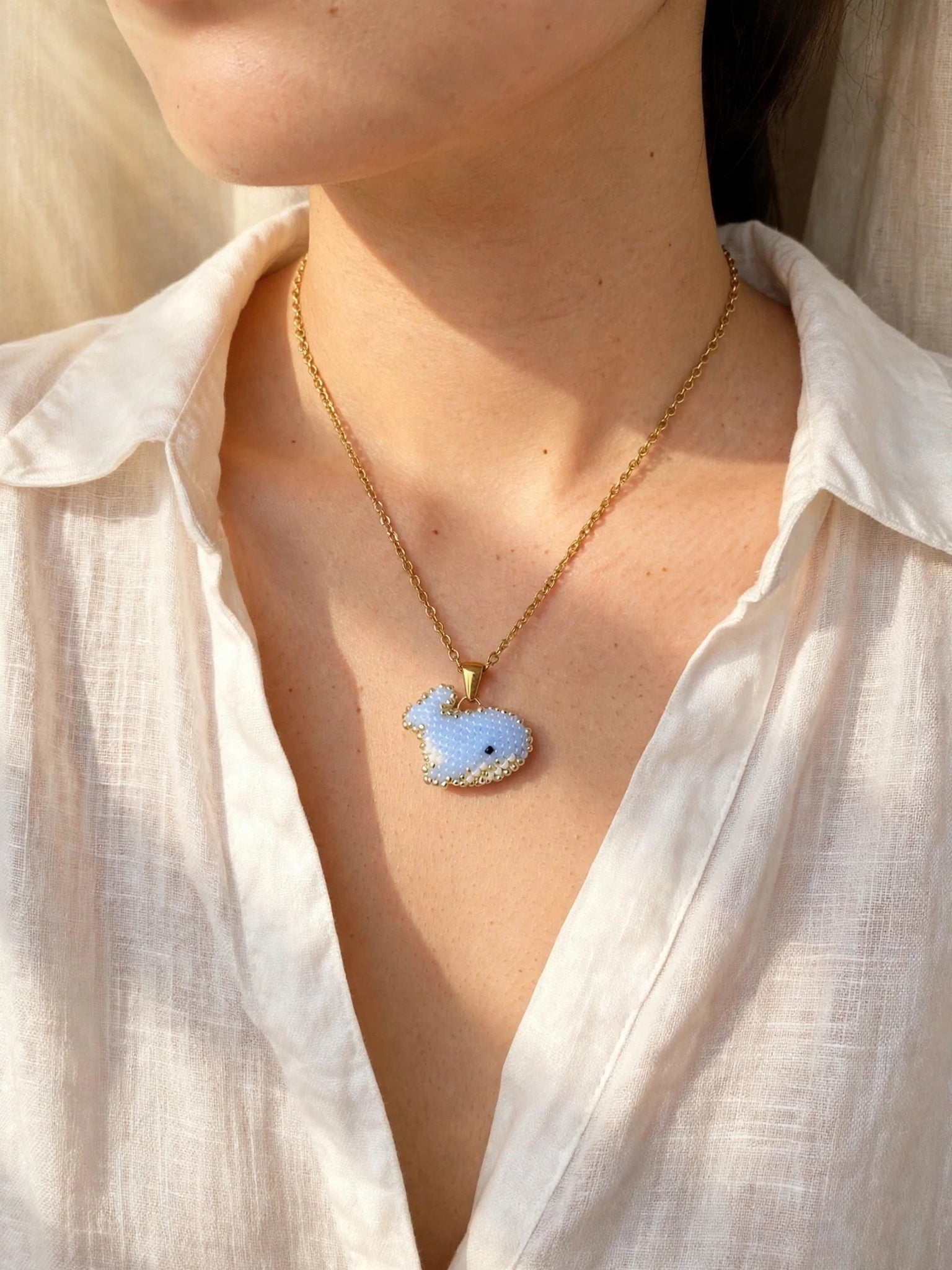 Blue whale necklace on model