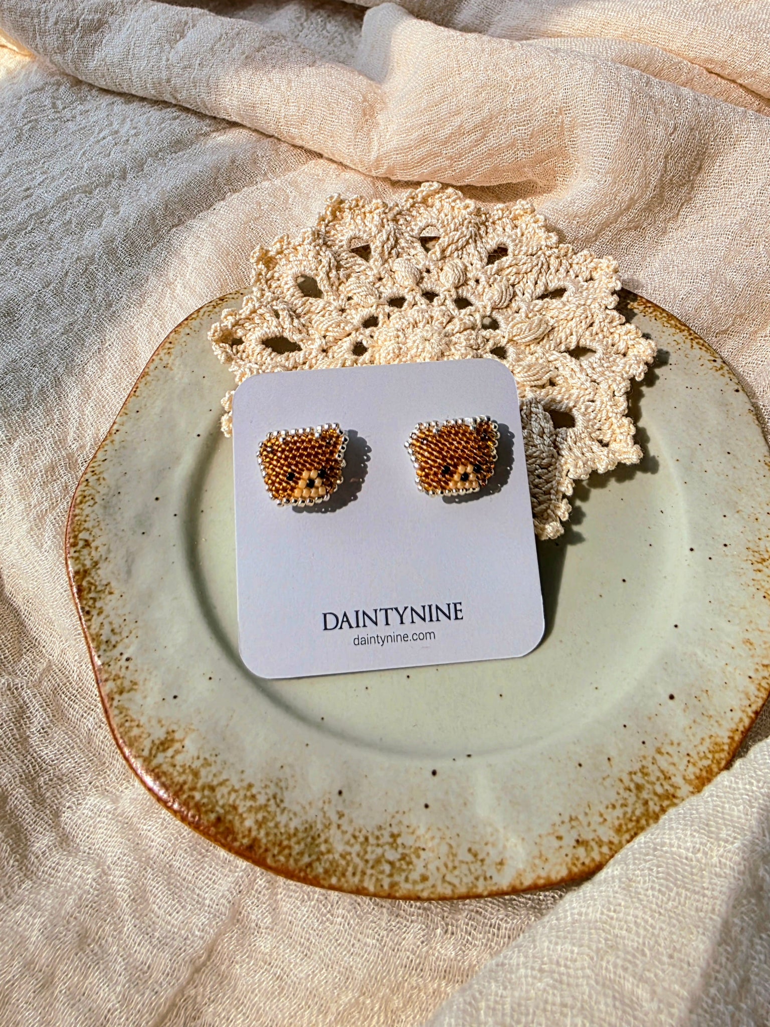 Brown bear stud earrings on card