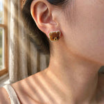 Brown bear stud earrings on model