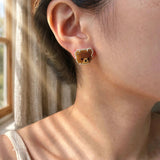Brown bear stud earrings on model