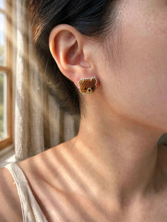 Brown bear stud earrings on model