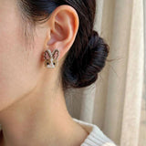 Brown bunny stud earrings on model