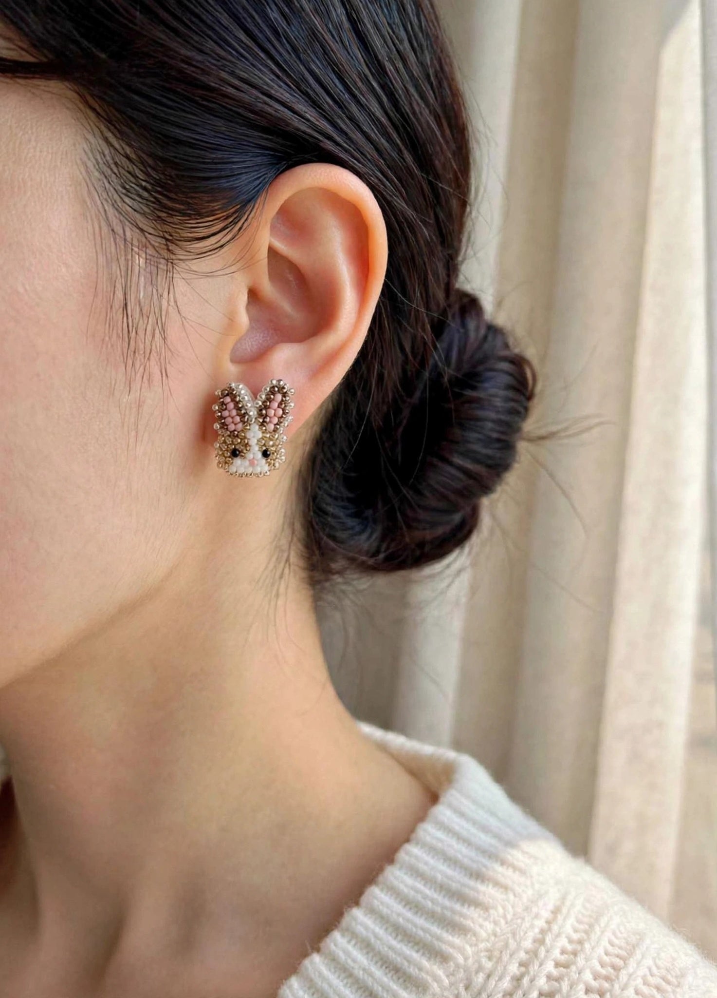Brown bunny stud earrings on model