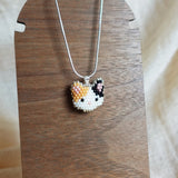 Calico Cat Necklace in Orange and Black Display Left