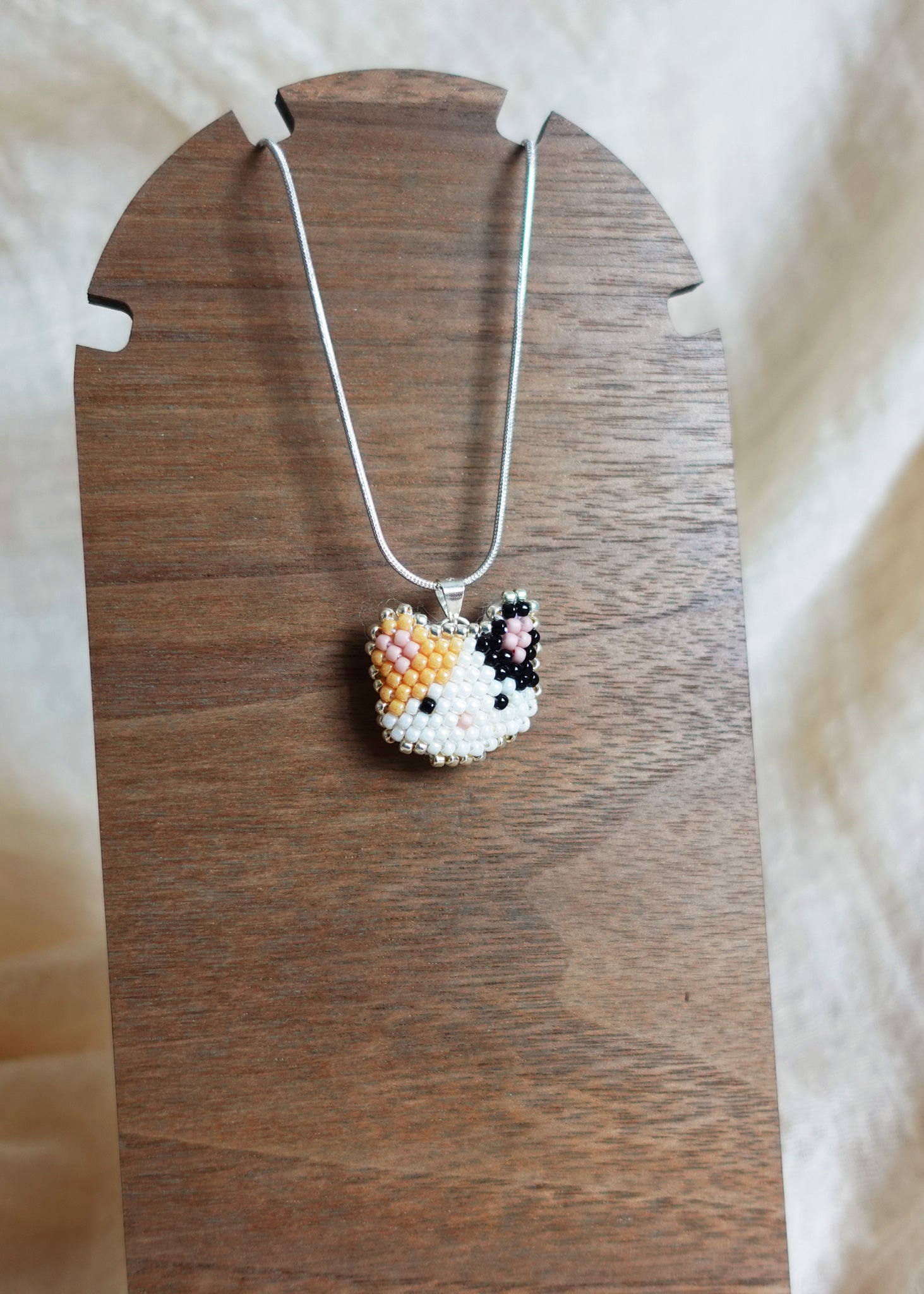Calico Cat Necklace in Orange and Black Display Left