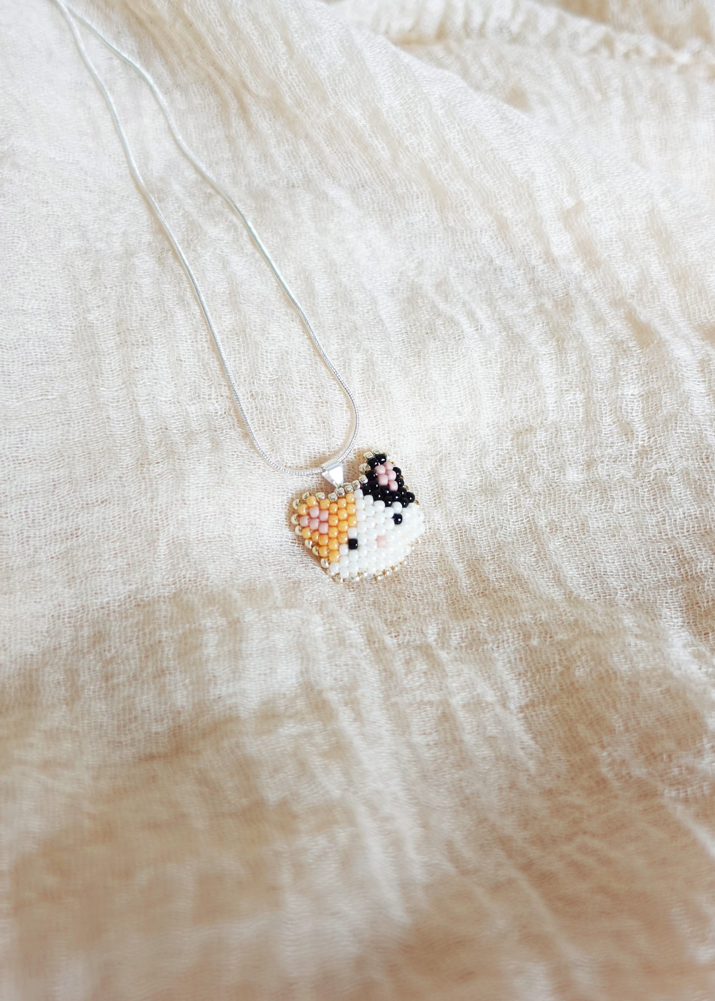 Calico Cat Necklace in Orange and Black Left