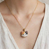 Calico cat necklace on model