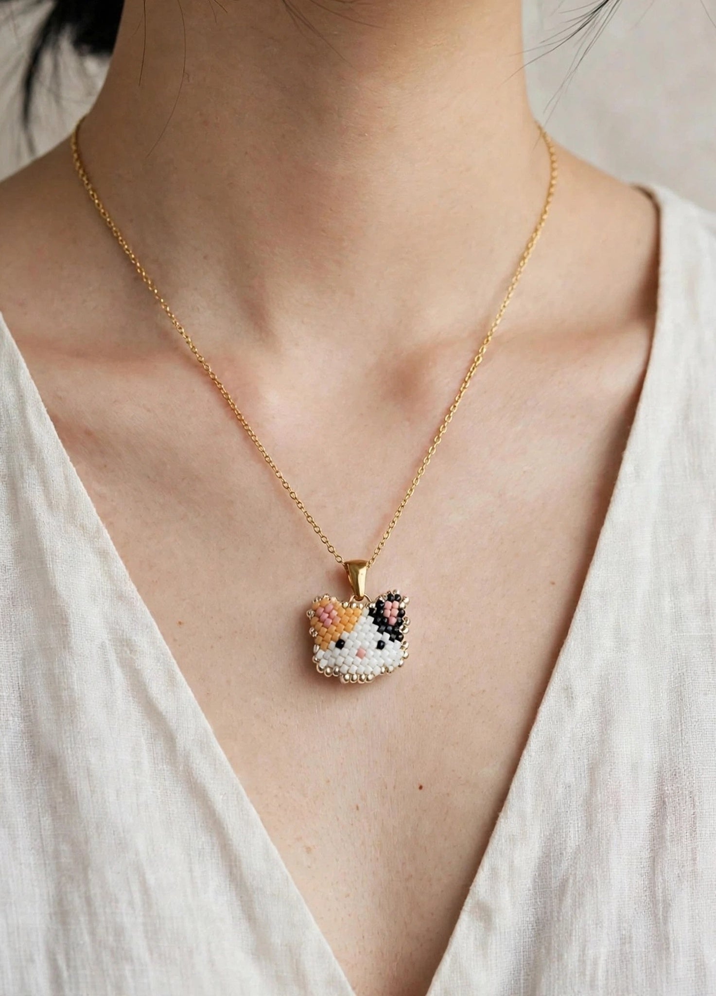 Calico cat necklace on model