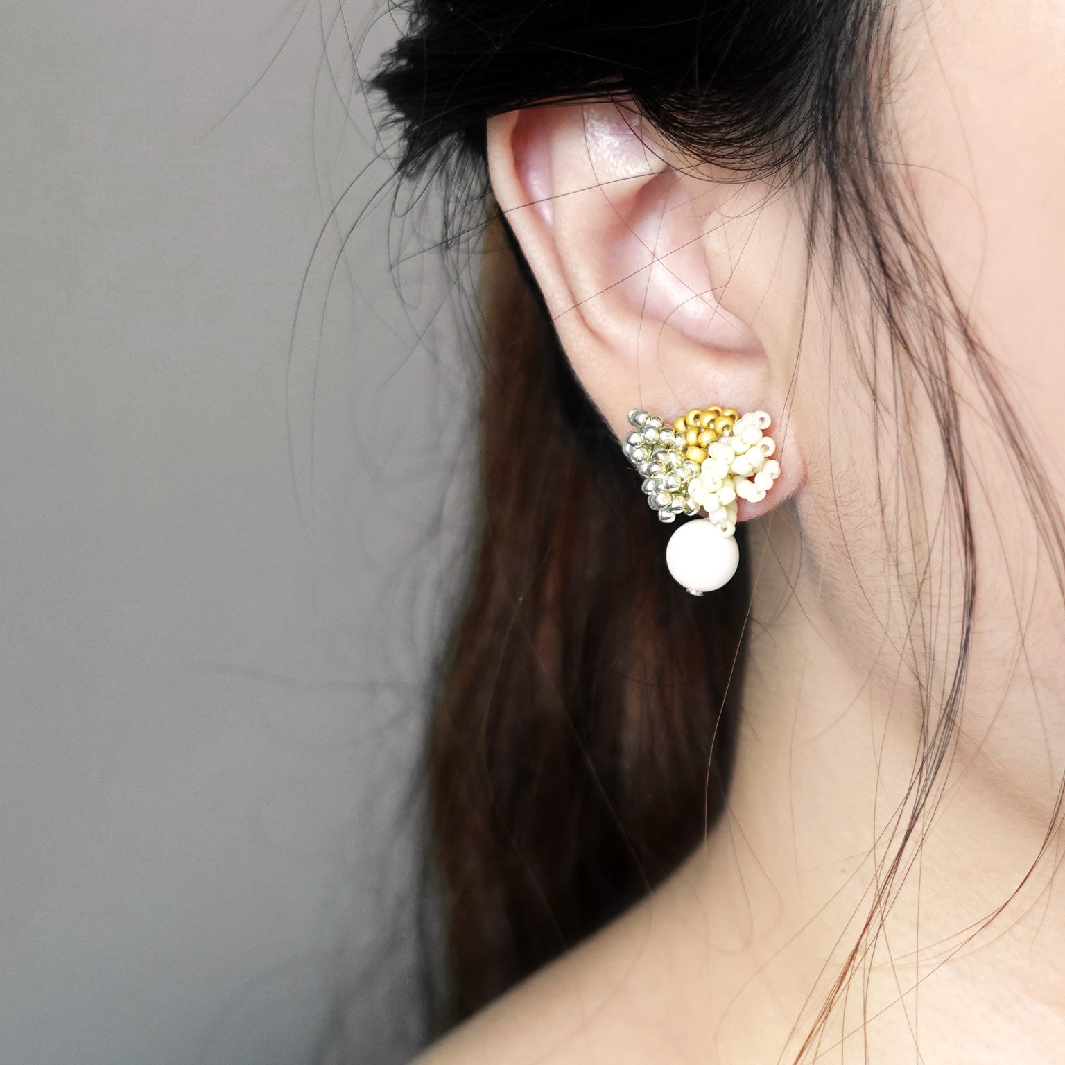 Camellia Cream Drop Earrings in Mustard Yellow Model