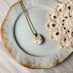 Cream tabby cat necklace left