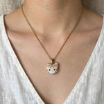 Cream tabby cat necklace on model